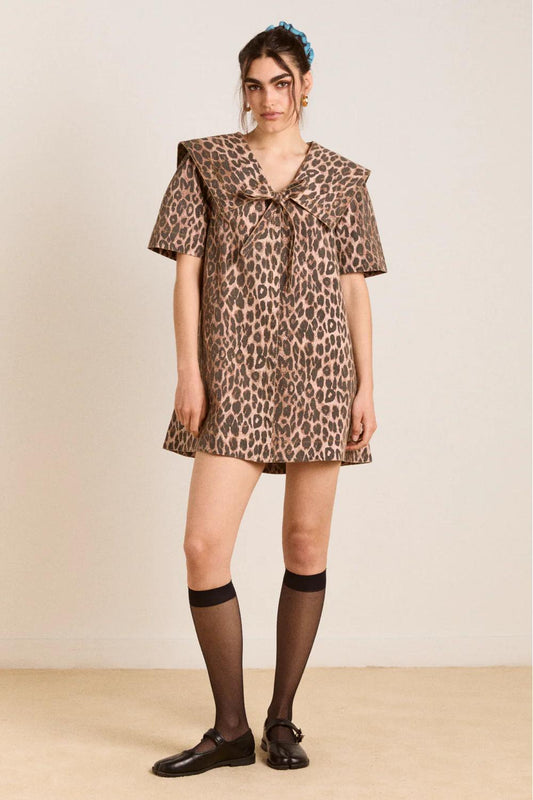 Women's structured mini shift dress featuring an oversized collar with a tie-front detail, short sleeves, and an all-over leopard print.