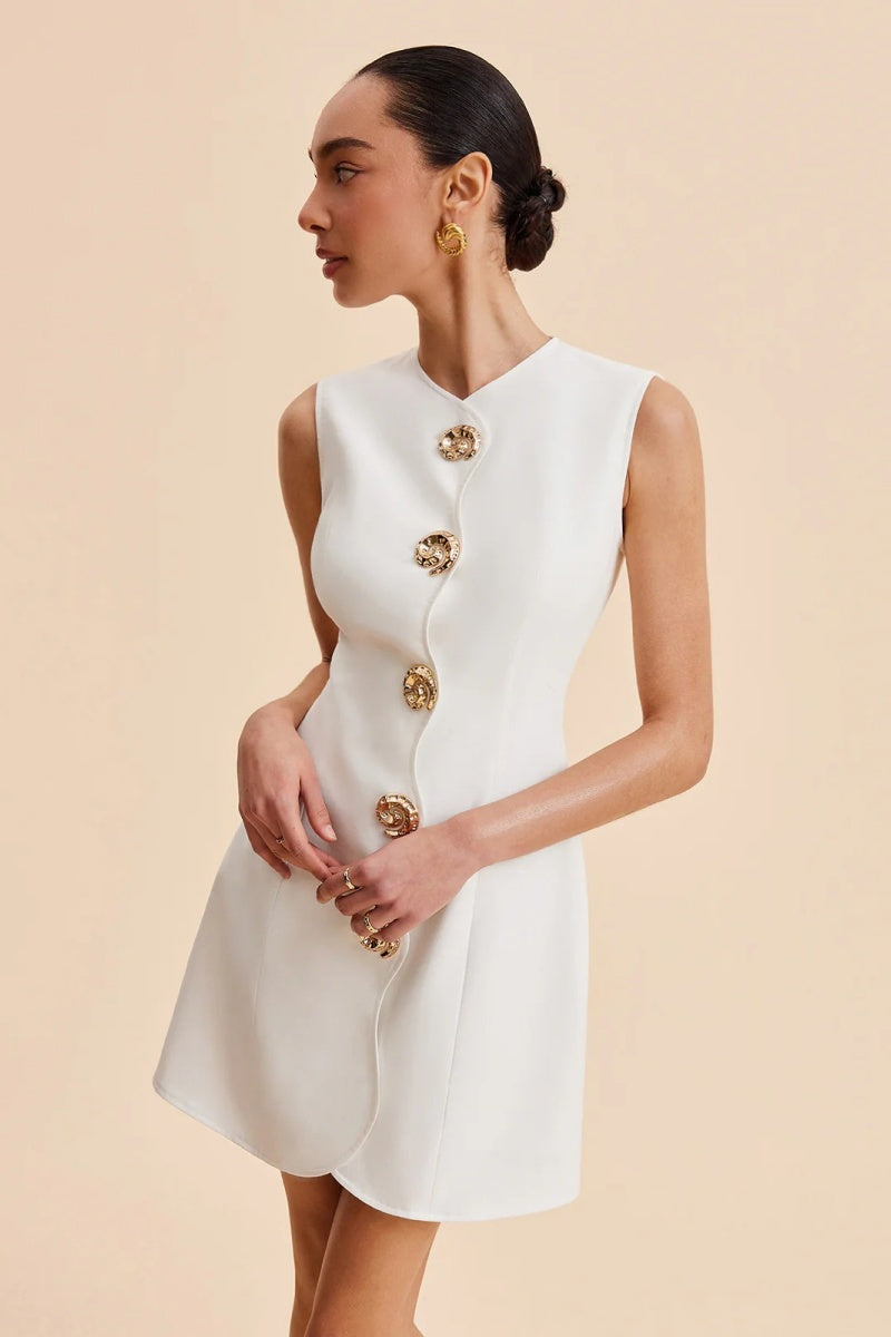 White - Women's white sleeveless tailored mini dress featuring an asymmetrical wavy front placket and large ornate statement buttons.