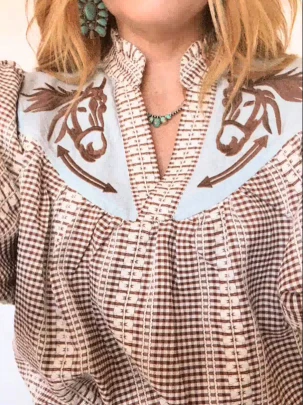 Red - Women's relaxed fit blouse in a red and white gingham pattern, featuring a contrasting light blue V-neck yoke with brown embroidered horse motifs and short puff sleeves.