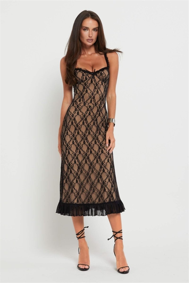 Black - A woman modelling a fitted midi dress featuring a black floral lace overlay over a nude lining, complete with ruffled straps, a corset-style bodice, and a frilled hem.