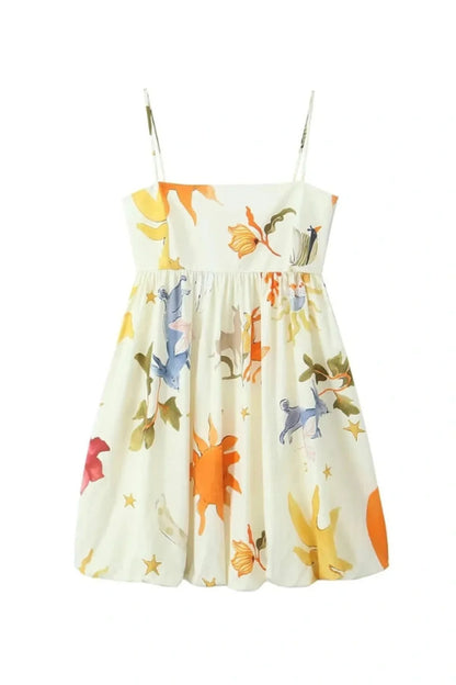 Woman wearing a white mini dress with a vibrant, large-scale abstract floral print, spaghetti straps, and a voluminous bubble hem.