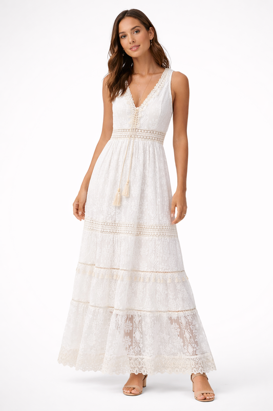White - Sleeveless lace boho maxi dress featuring a V-neckline, crochet-style trims, front tassel ties, and a tiered skirt on a model against a plain background.