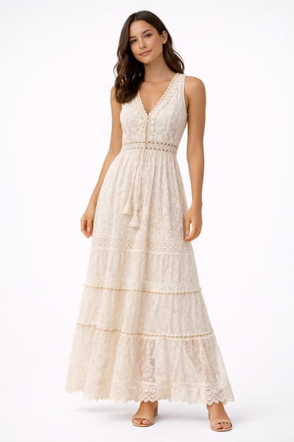 Beige - Sleeveless lace boho maxi dress featuring a V-neckline, crochet-style trims, front tassel ties, and a tiered skirt on a model against a plain background.
