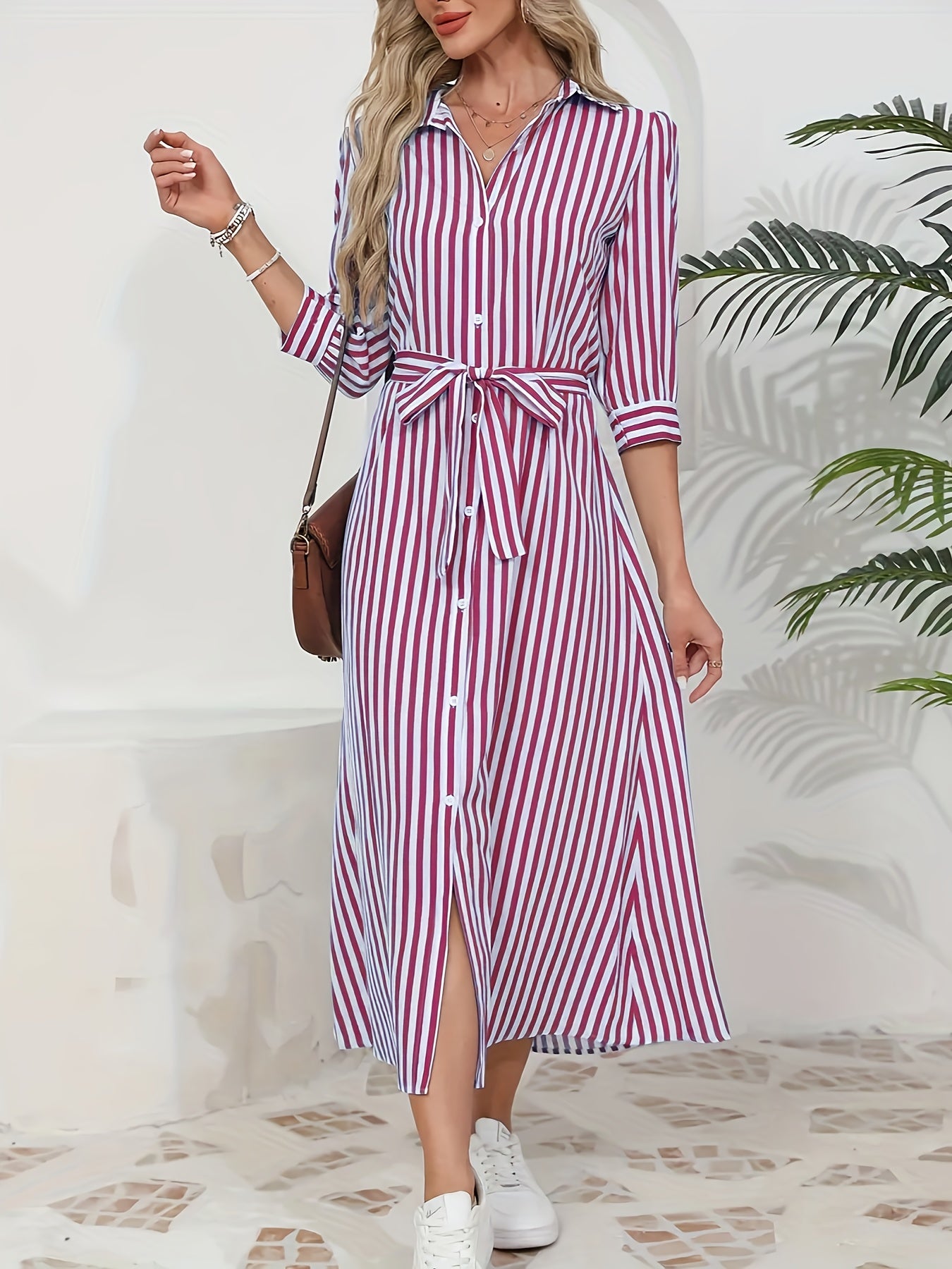 Black - Woman wearing a striped poplin midi shirt dress with 3/4 sleeves, a collared neckline, and a tie waist, styled with white trainers.