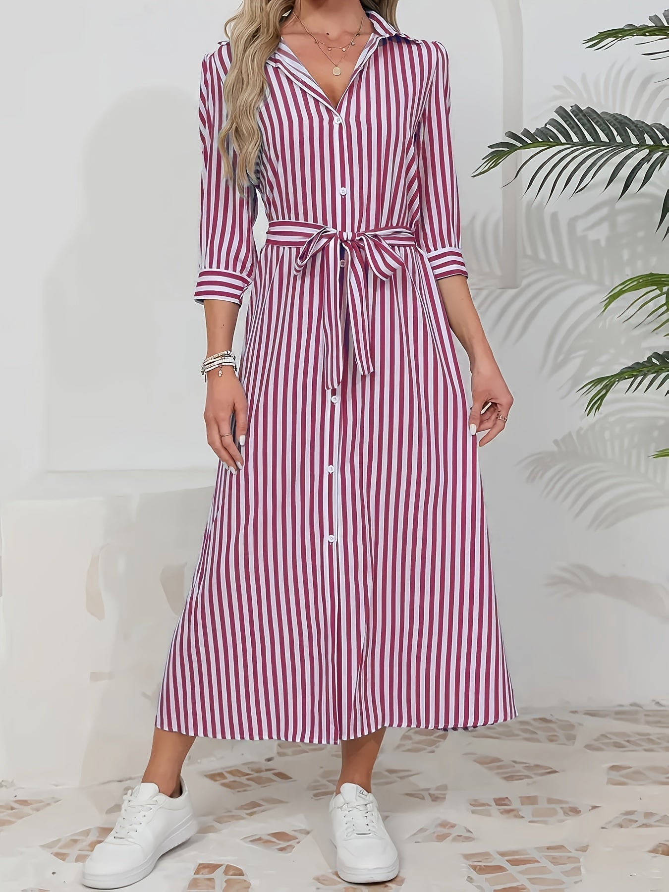 Black - Woman wearing a striped poplin midi shirt dress with 3/4 sleeves, a collared neckline, and a tie waist, styled with white trainers.