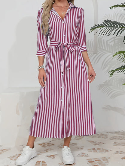 Black - Woman wearing a striped poplin midi shirt dress with 3/4 sleeves, a collared neckline, and a tie waist, styled with white trainers.