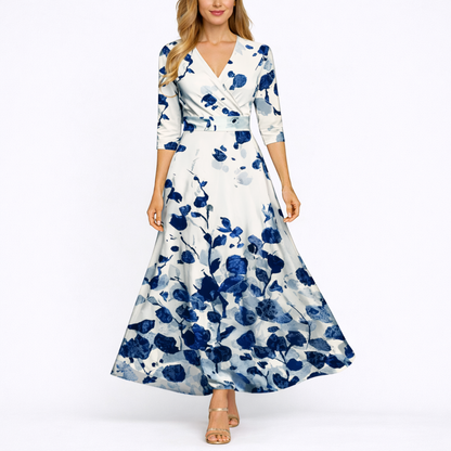 Blue & White - Woman wearing a long satin floral maxi dress with 3/4 sleeves, a V-neckline, and a sweeping A-line skirt.