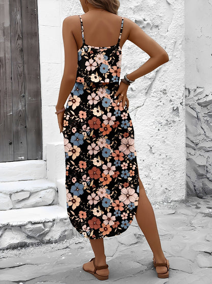 Mixed Colors - Model wearing a lightweight woven strappy midi dress with an abstract vertical pattern, adjustable waist tie, and side split, standing outdoors against a white textured wall.