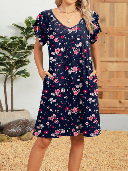 Dark Blue - Woman wearing a lightweight woven animal-print shift dress with a V-neckline and short flutter sleeves, styled with a woven bag.