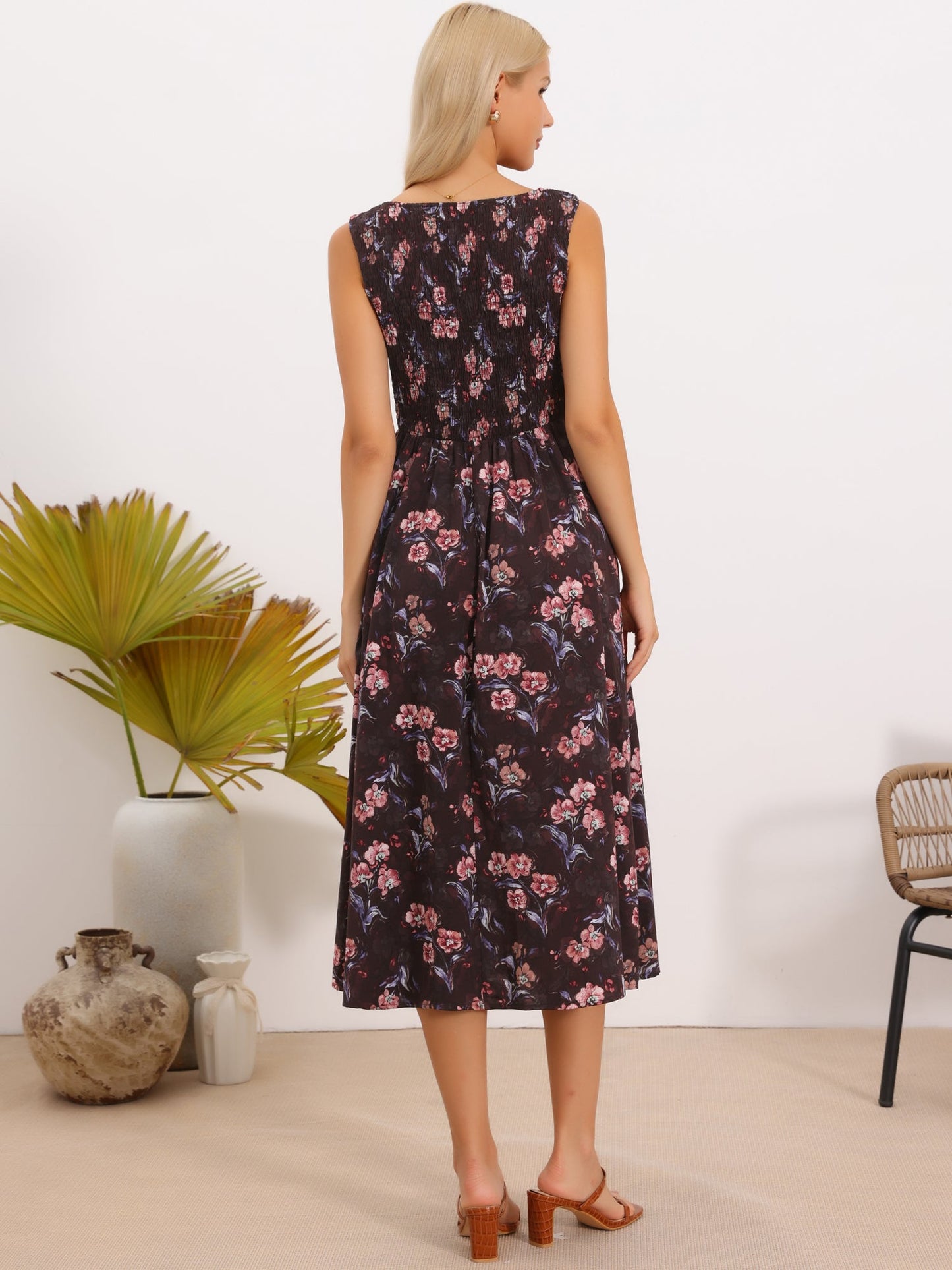 Brown Red Floral - Model wearing a sleeveless floral A-line midi dress with a square neckline and front button detailing, posing in a bright studio setting.