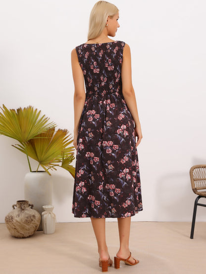Brown Red Floral - Model wearing a sleeveless floral A-line midi dress with a square neckline and front button detailing, posing in a bright studio setting.