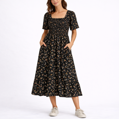 Black - Model wearing a woven floral square-neck midi dress with a smocked bodice, short sleeves, and a ruffle hemline.