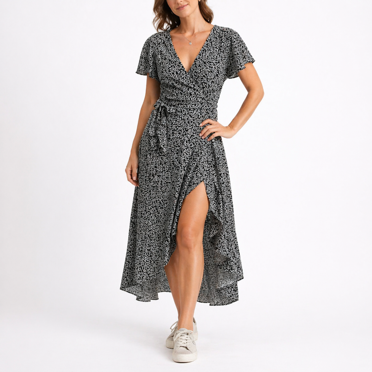 Black - Woman wearing a woven spotted wrap midi dress with short sleeves, a tie waist, and a high-low hemline.
